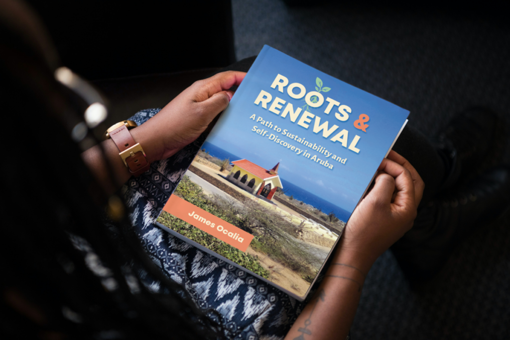 Female person holding book Roots and Renewal Aruba